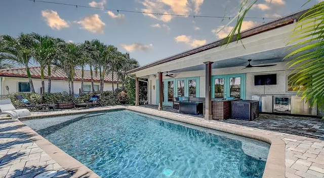 a view of a patio with table and chairs potted plants and large tree