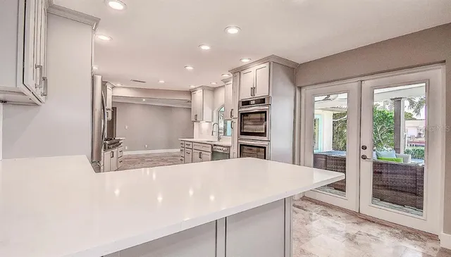 a kitchen with stainless steel appliances a refrigerator and a stove top oven