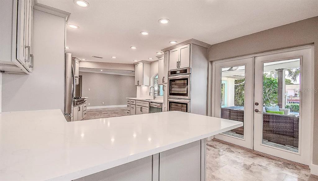 1998 Kansas Avenue Northeast St. Petersburg, FL 33703 - Photo 5 of 14 a kitchen with stainless steel appliances a refrigerator and a stove top oven