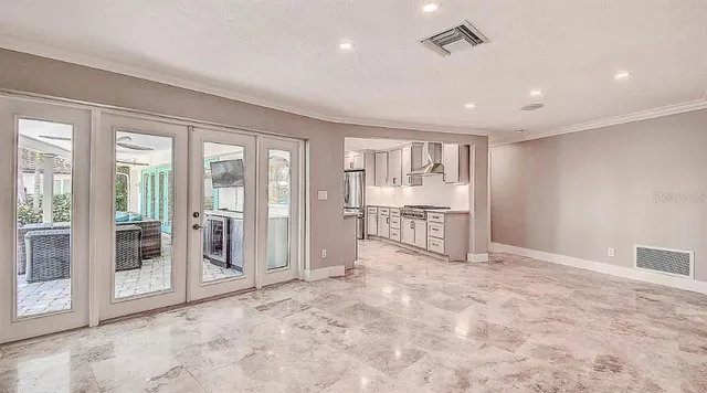 a view of a livingroom with wooden floor and a ceiling fan