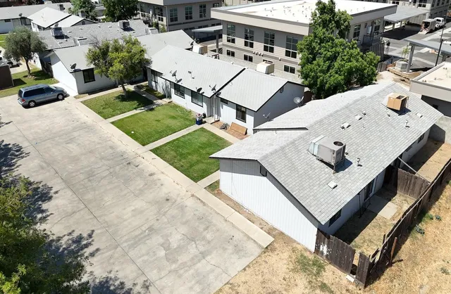 an aerial view of a house with a yard