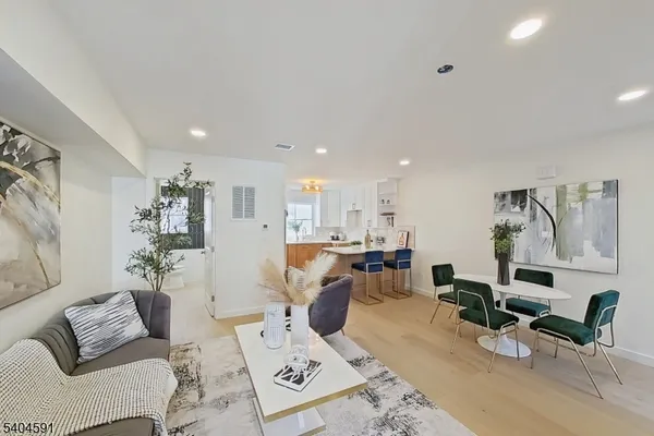 a living room with furniture and view of kitchen