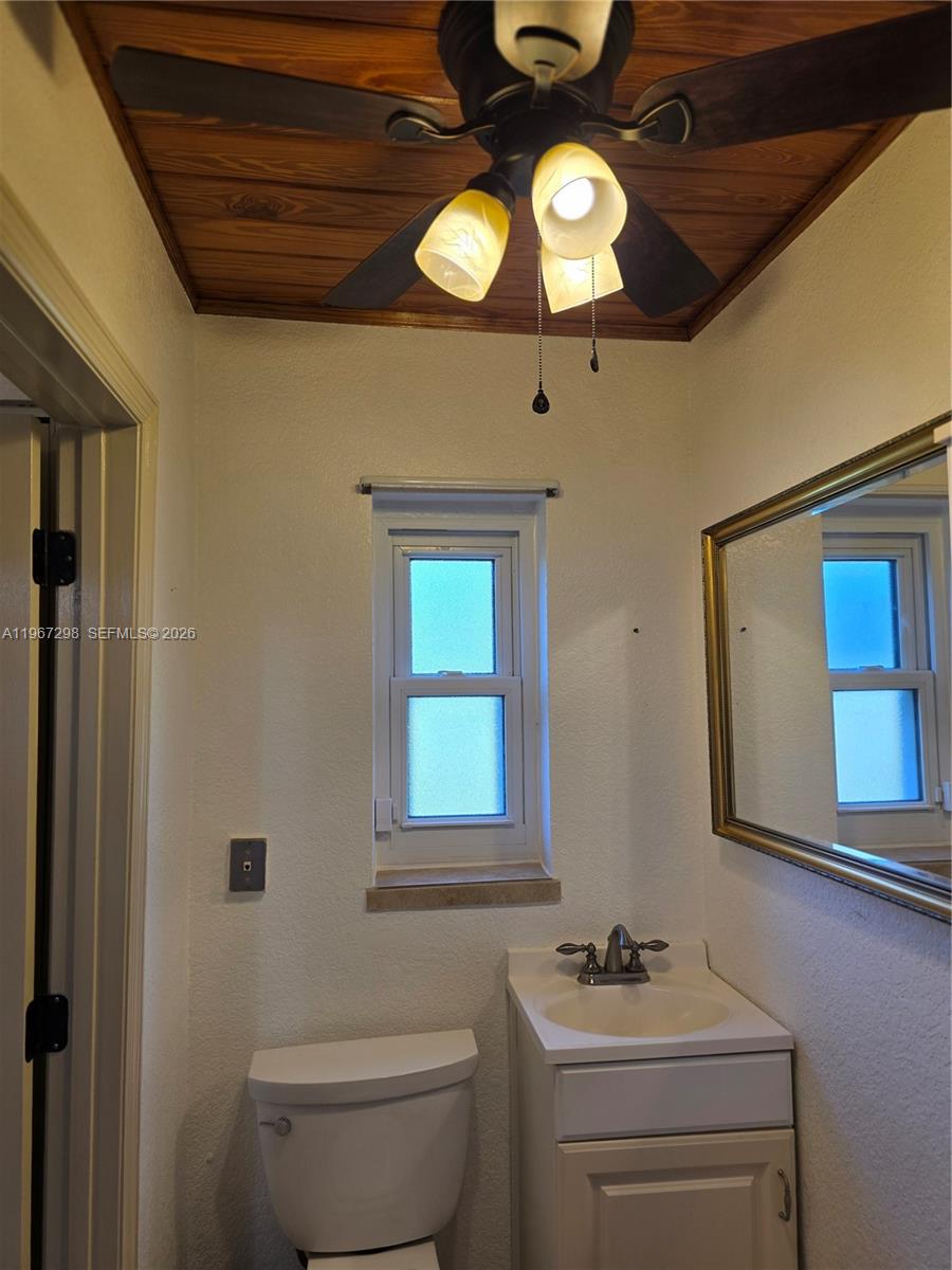 4321 Kirby Loop Road, Unit 1 Fort Pierce, FL 34981 - Photo 18 of 21 a bathroom with a sink a light fixture and a toilet