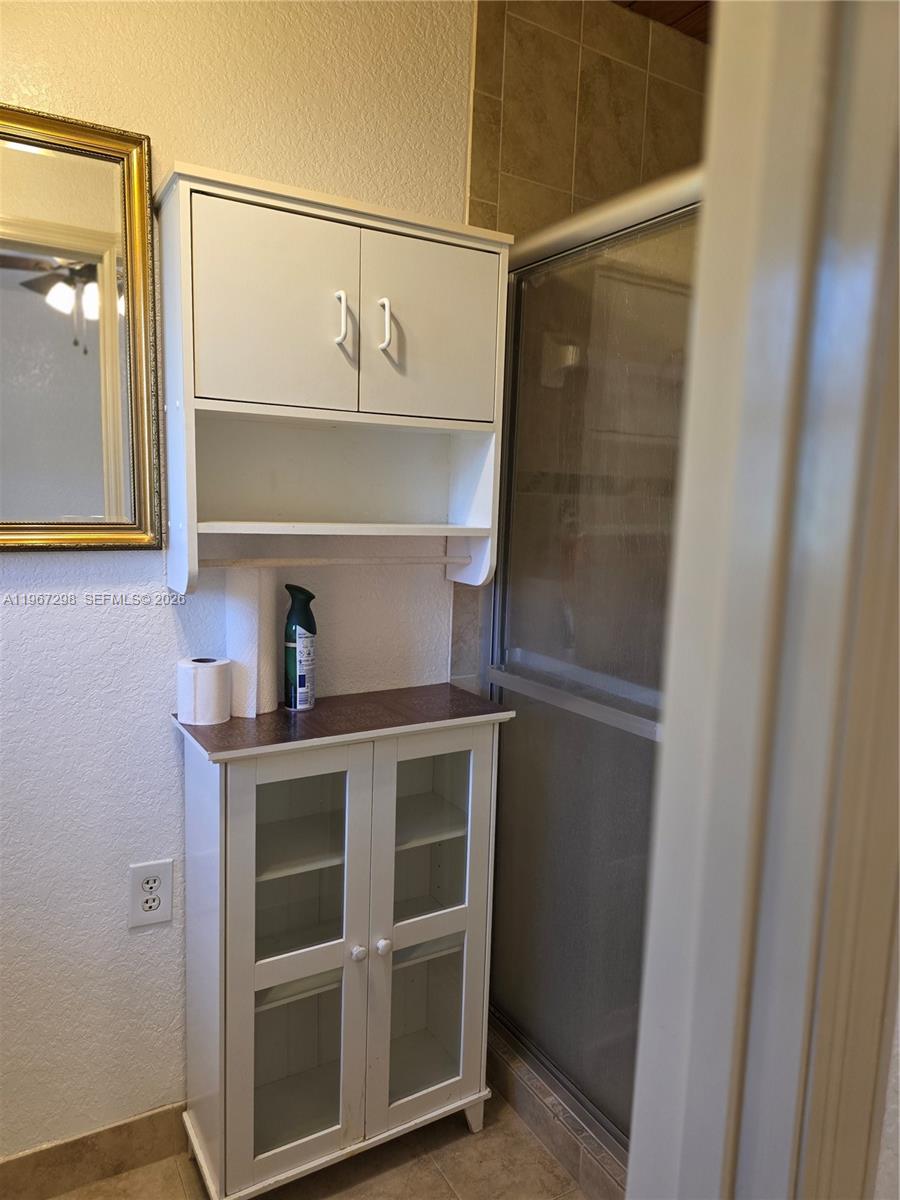 4321 Kirby Loop Road, Unit 1 Fort Pierce, FL 34981 - Photo 20 of 21 a kitchen with a refrigerator and cabinets