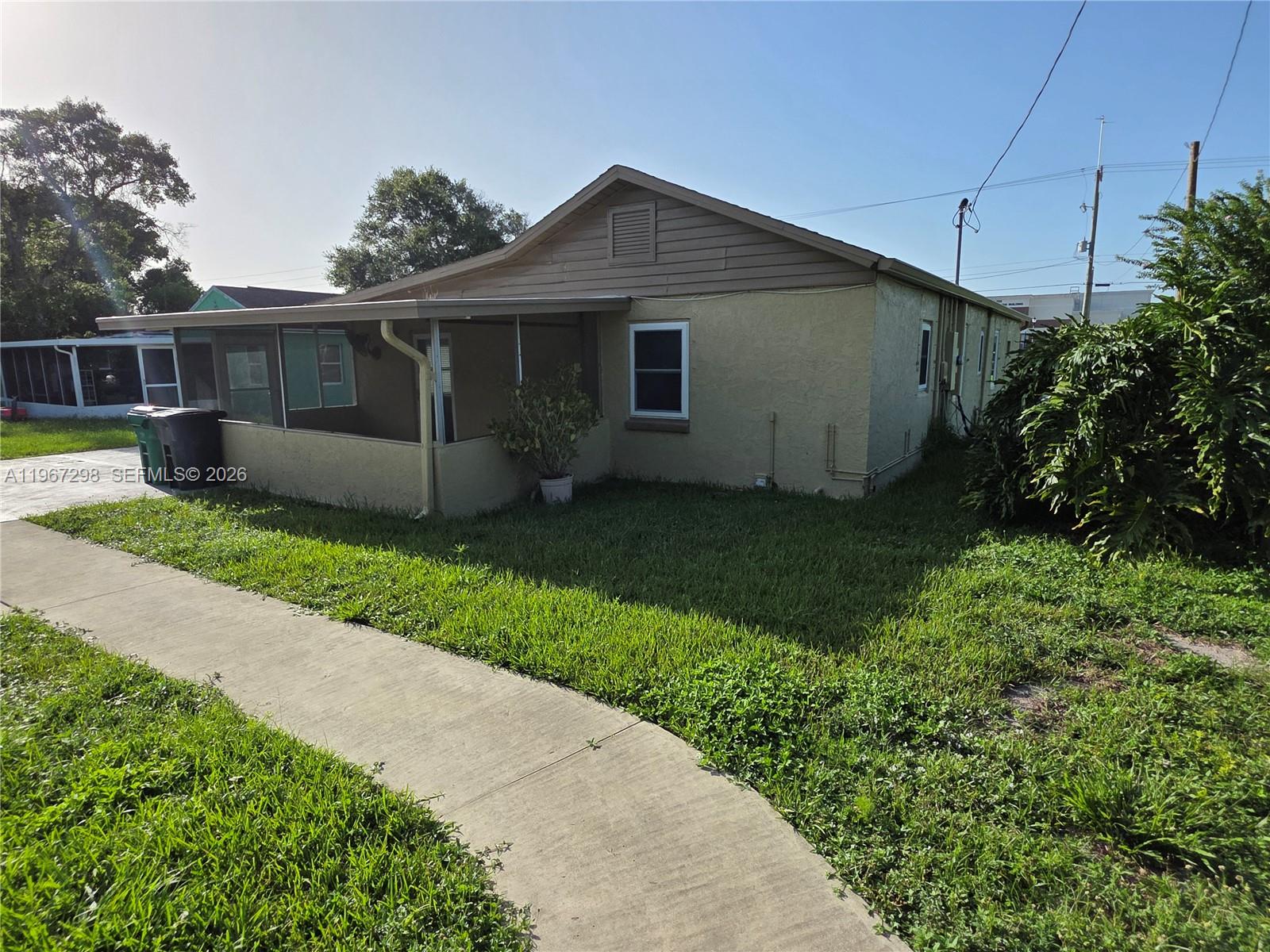 4321 Kirby Loop Road, Unit 1 Fort Pierce, FL 34981 - Photo 3 of 21 a front view of a house with garden