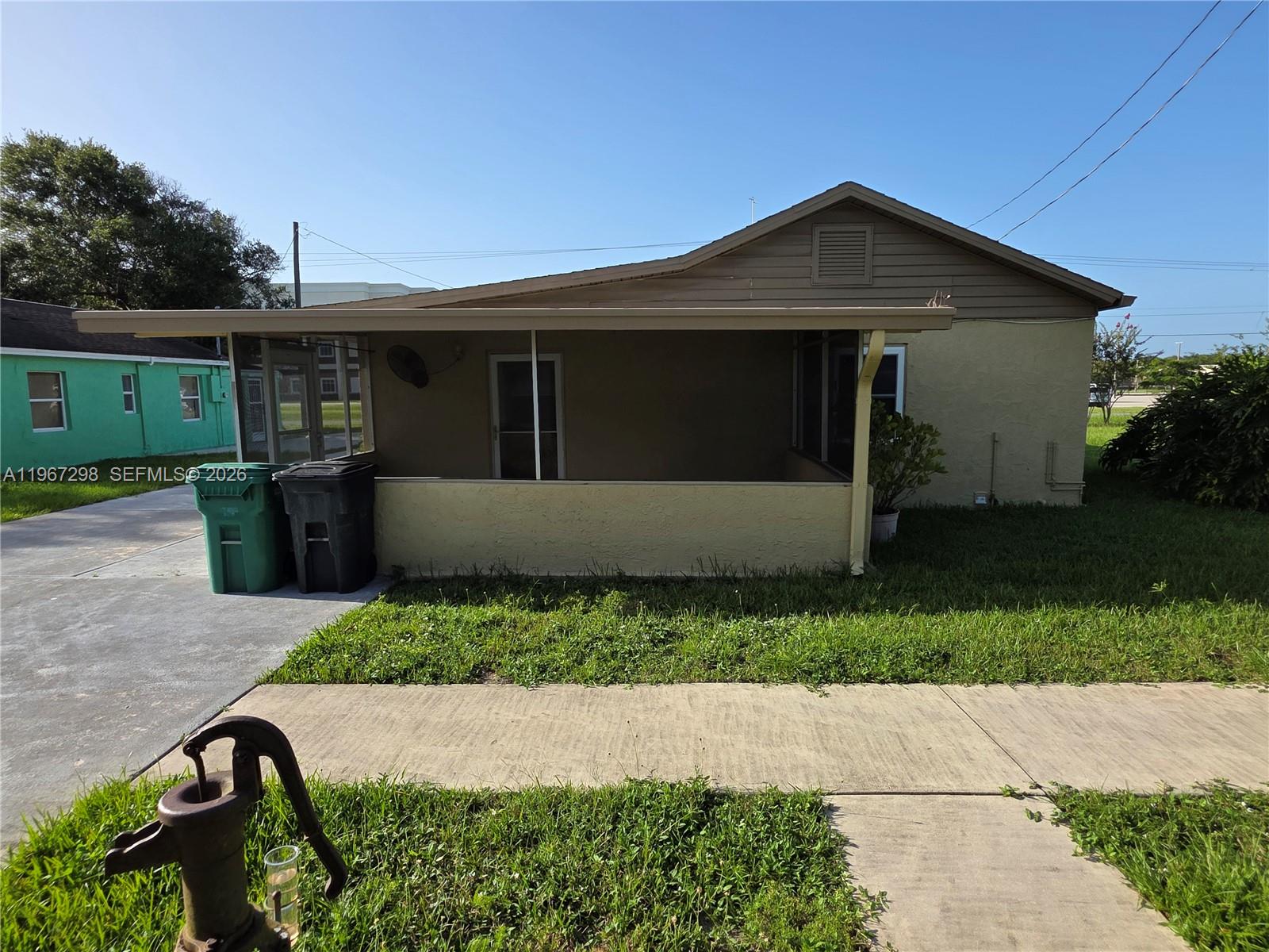4321 Kirby Loop Road, Unit 1 Fort Pierce, FL 34981 - Photo 4 of 21 a front view of a house with a yard and garage