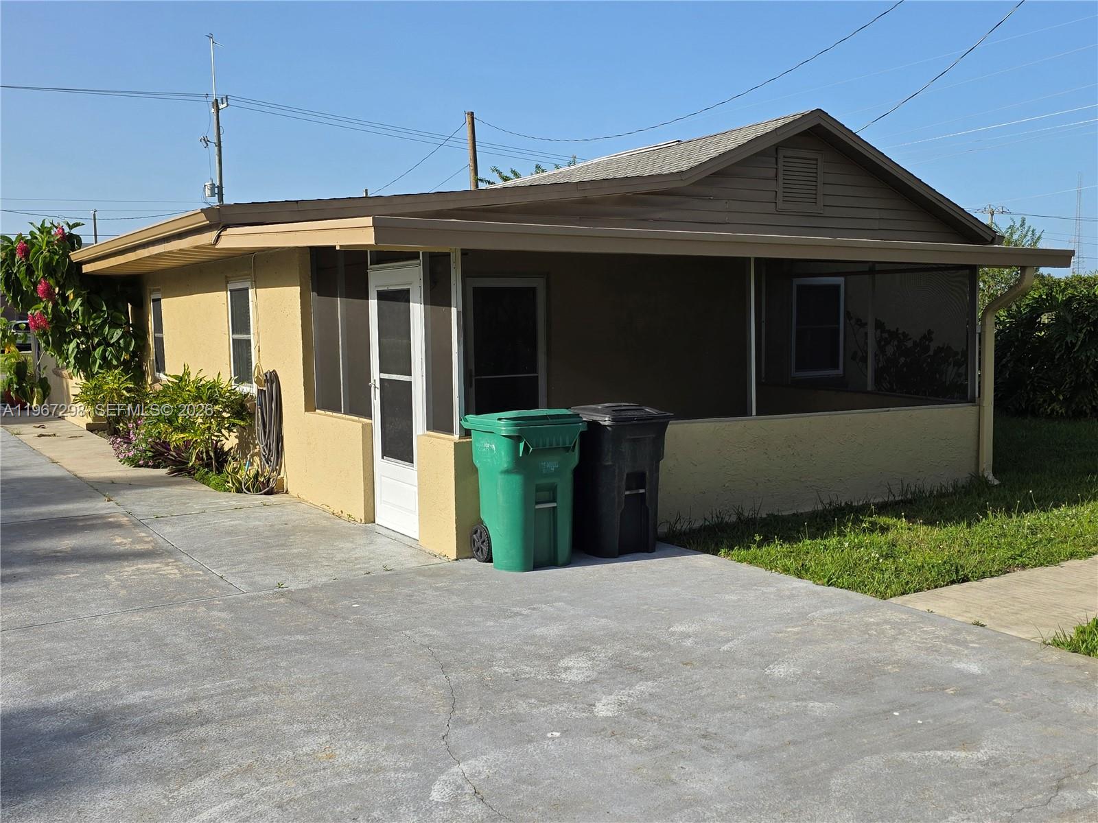 4321 Kirby Loop Road, Unit 1 Fort Pierce, FL 34981 - Photo 5 of 21 a front view of a house with garden