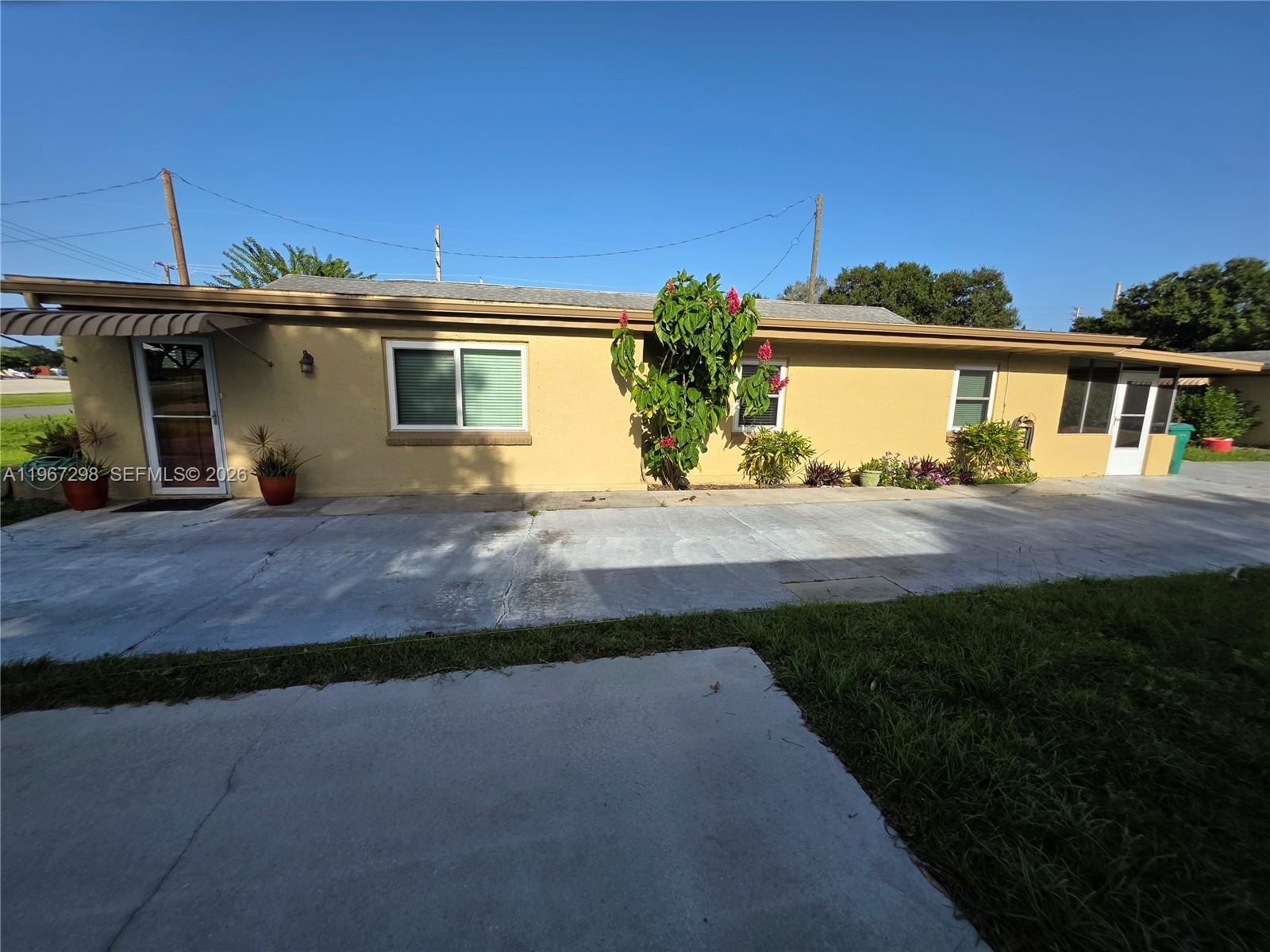 4321 Kirby Loop Road, Unit 1 Fort Pierce, FL 34981 - Photo 6 of 21 a front view of a house with a yard and potted plants