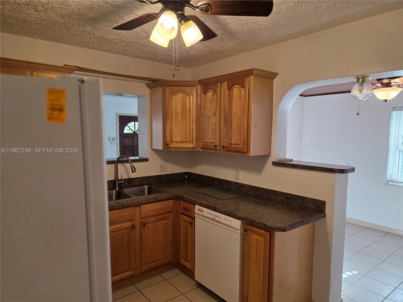 4321 Kirby Loop Road, Unit 1 Fort Pierce, FL 34981 - Photo 9 of 21 a kitchen with a refrigerator and a sink