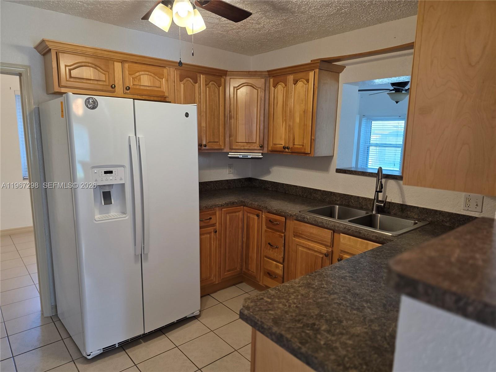 4321 Kirby Loop Road, Unit 1 Fort Pierce, FL 34981 - Photo 10 of 21 a kitchen with stainless steel appliances granite countertop a refrigerator a sink and dishwasher