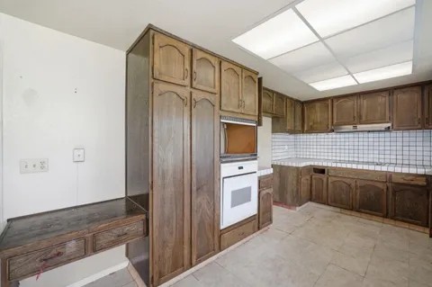a kitchen with stainless steel appliances granite countertop a refrigerator and a stove