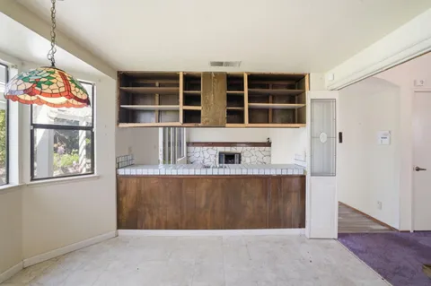 a kitchen with kitchen island granite countertop wooden cabinets a sink and dishwasher