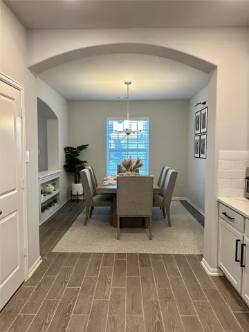 a dining room with furniture and window