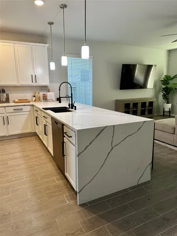 a kitchen with stainless steel appliances granite countertop a sink a stove a microwave and a refrigerator