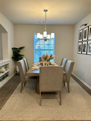 a dining room with furniture and window