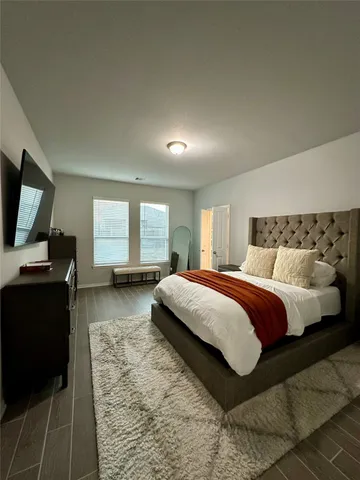 a spacious bedroom with a bed and a couch