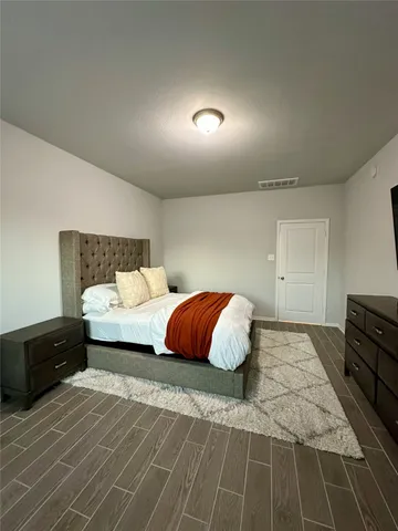 a bedroom with a bed and a dresser