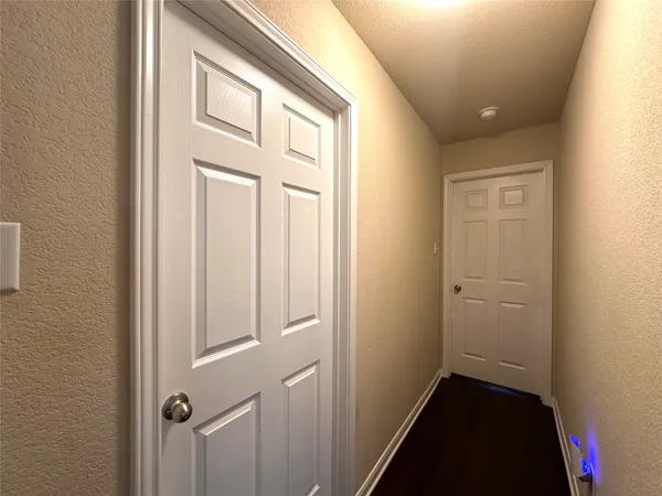 an empty room with closet and a ceiling fan