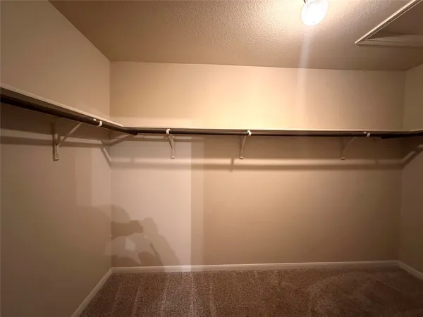 a bathroom with double vanity and a mirror
