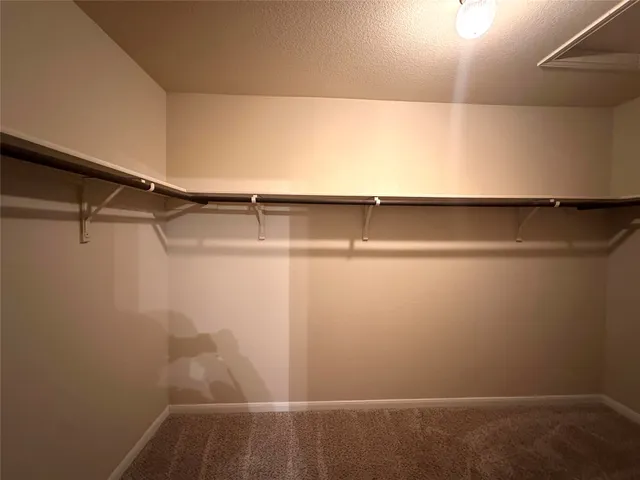 a bathroom with double vanity and a mirror