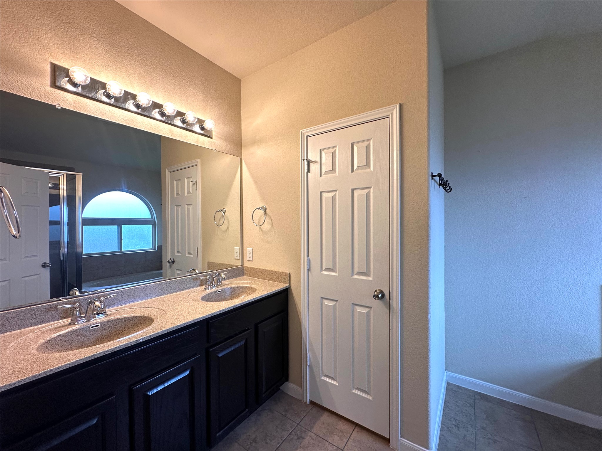 1000 Drake Cove Leander, TX 78641 - Photo 16 of 24 a bathroom with double vanity and a mirror