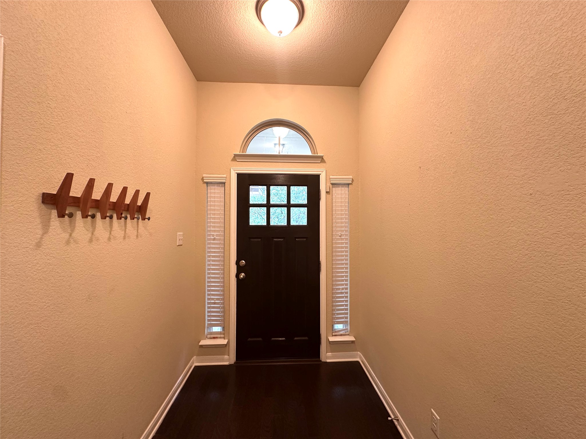 1000 Drake Cove Leander, TX 78641 - Photo 5 of 24 a view of a hallway with wooden floor and a bathroom