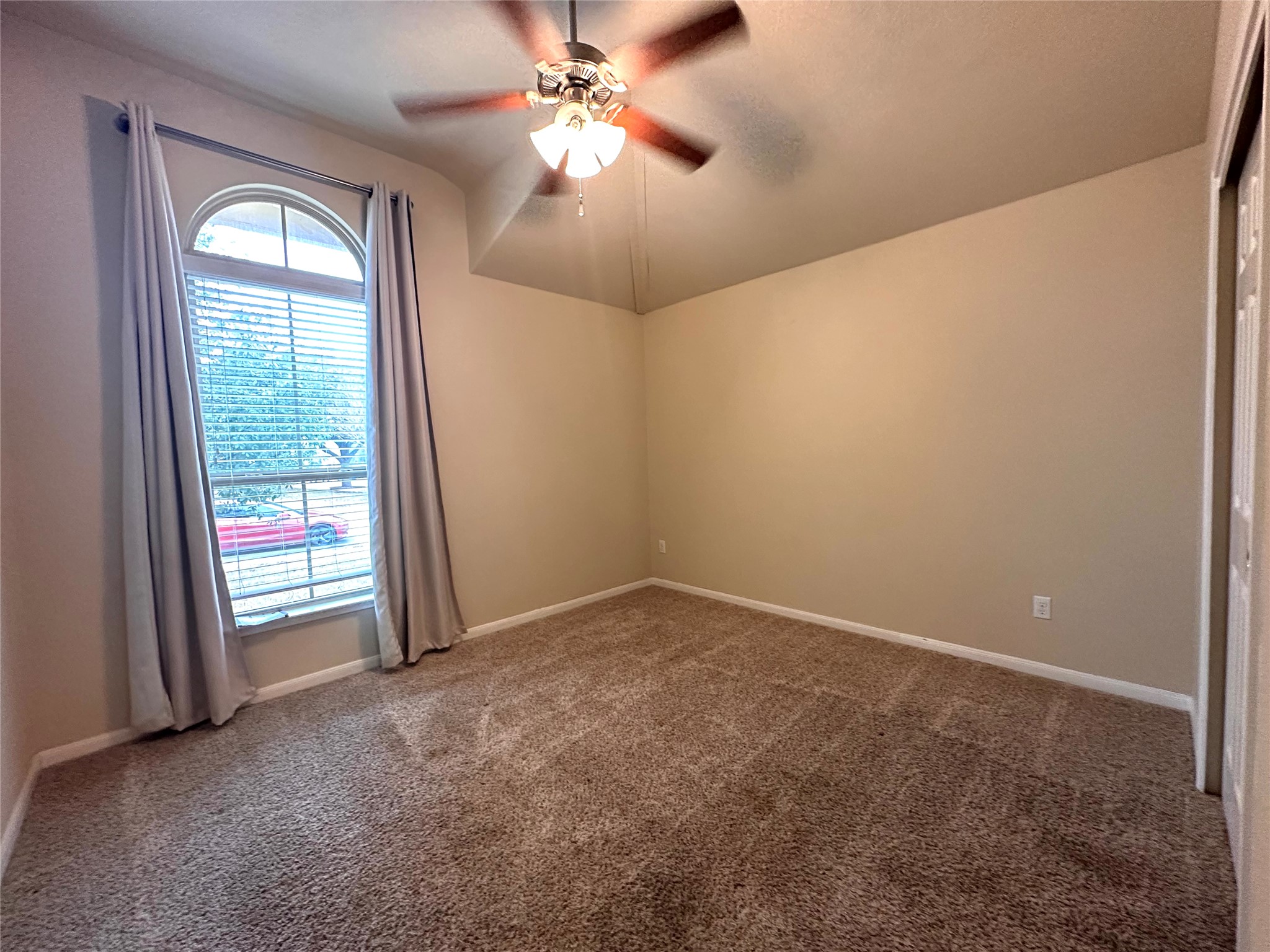1000 Drake Cove Leander, TX 78641 - Photo 7 of 24 an empty room with chandelier fan and windows