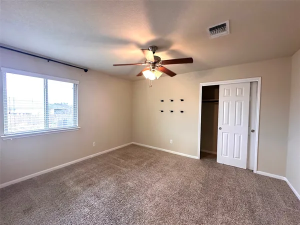 a large kitchen with kitchen island a stove a counter space a sink and cabinets