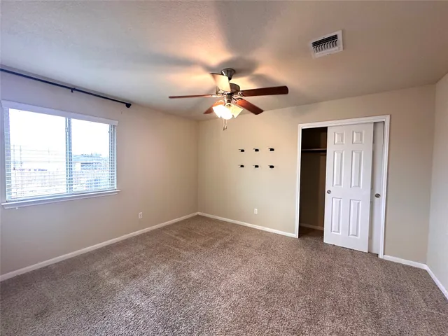 a large kitchen with kitchen island a stove a counter space a sink and cabinets