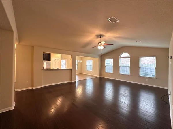 a large kitchen with a large counter top stainless steel appliances and cabinets