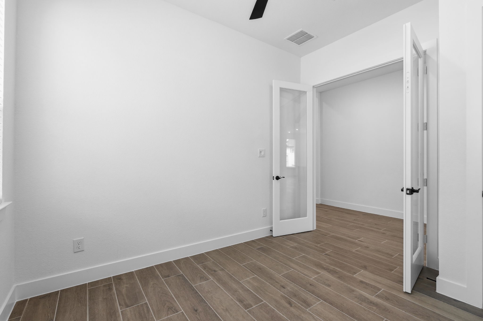 633 Cross Timbers Trace Waller, TX 77484 - Photo 27 of 42 a view of an empty room with wooden floor