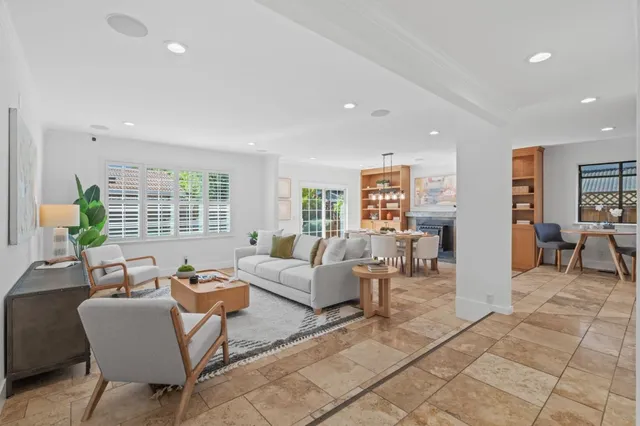 a living room with fireplace furniture and a window
