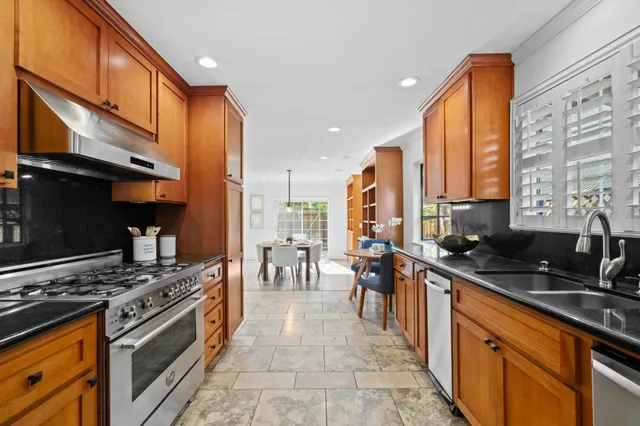 a kitchen with stainless steel appliances a stove sink and cabinets