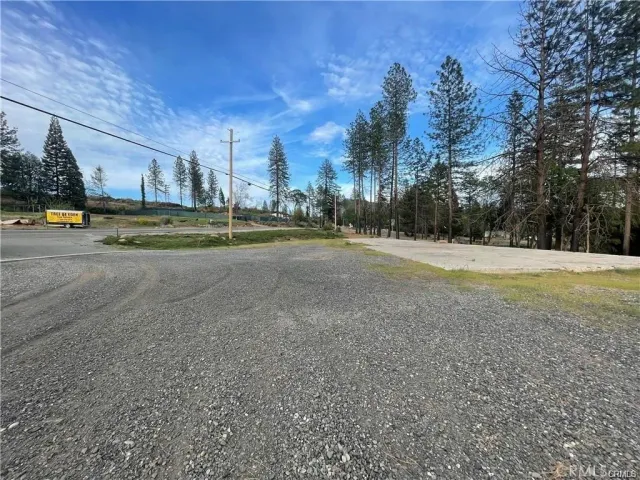 a view of dirt field with trees
