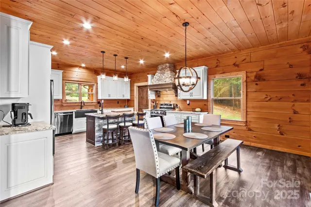 a view of a dining room with furniture and chandelier