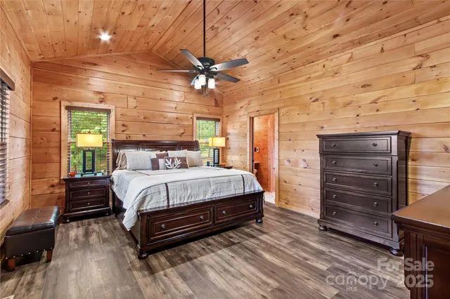 a bedroom with a bed and a ceiling fan