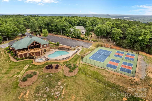 an aerial view of a house with swimming pool garden and mountain view