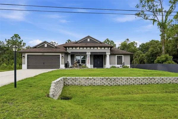 a front view of a house with a garden