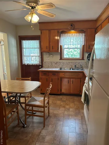 a kitchen with a stove a sink and a window