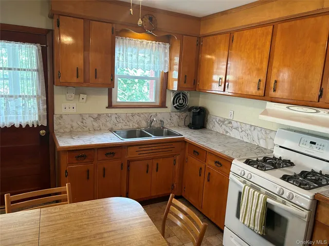 a kitchen with a stove a sink and a microwave
