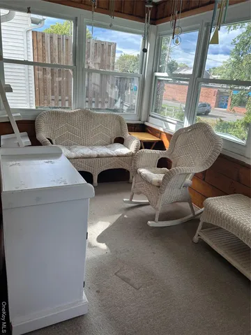 a view of a green field of grass and trees