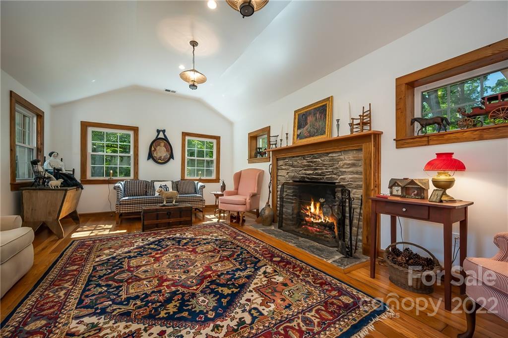 146 Hidden Hill Road Tryon, NC 28782 - Photo 12 of 43 a living room with furniture and a fireplace