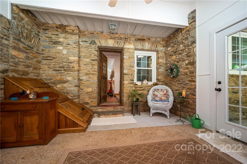 146 Hidden Hill Road Tryon, NC 28782 - Photo 16 of 43 a front view of a house with outdoor seating