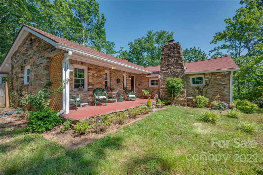 146 Hidden Hill Road Tryon, NC 28782 - Photo 2 of 43 a view of a chair and table in backyard of the house