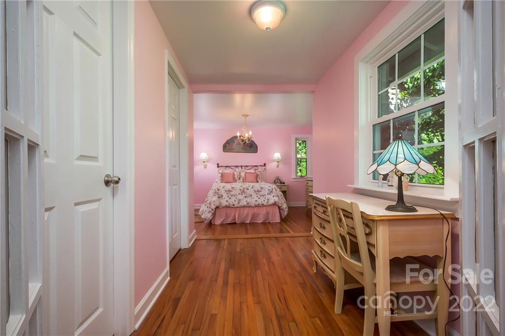 146 Hidden Hill Road Tryon, NC 28782 - Photo 22 of 43 a bedroom with furniture and a wooden floor