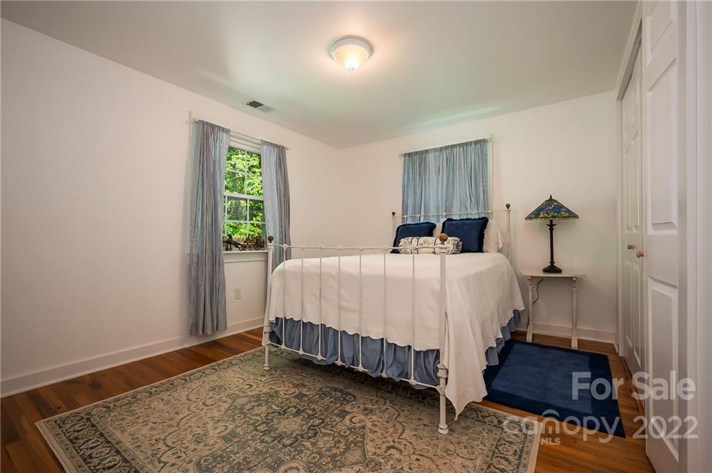 146 Hidden Hill Road Tryon, NC 28782 - Photo 23 of 43 a bedroom with a bed and a window