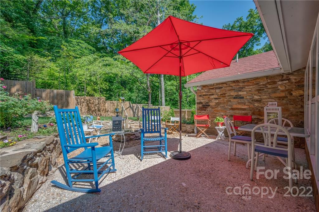 146 Hidden Hill Road Tryon, NC 28782 - Photo 28 of 43 a view of a chairs and table in the backyard