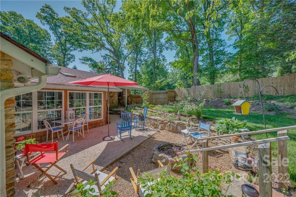 146 Hidden Hill Road Tryon, NC 28782 - Photo 33 of 43 an outdoor sitting area with furniture and garden view