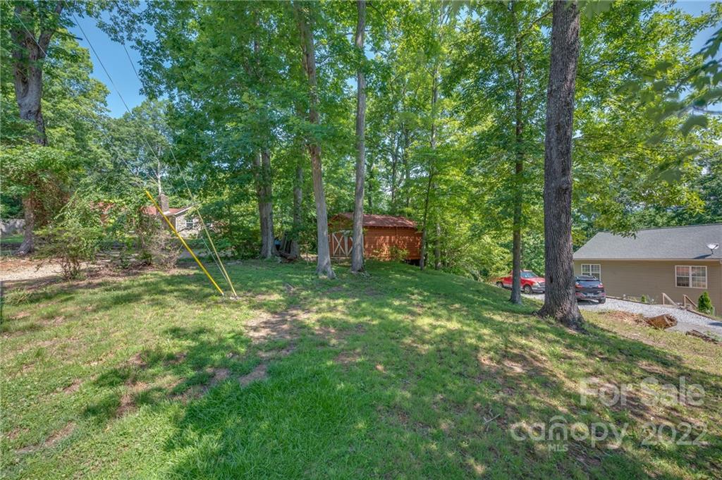 146 Hidden Hill Road Tryon, NC 28782 - Photo 37 of 43 a backyard of a house with lots of green space