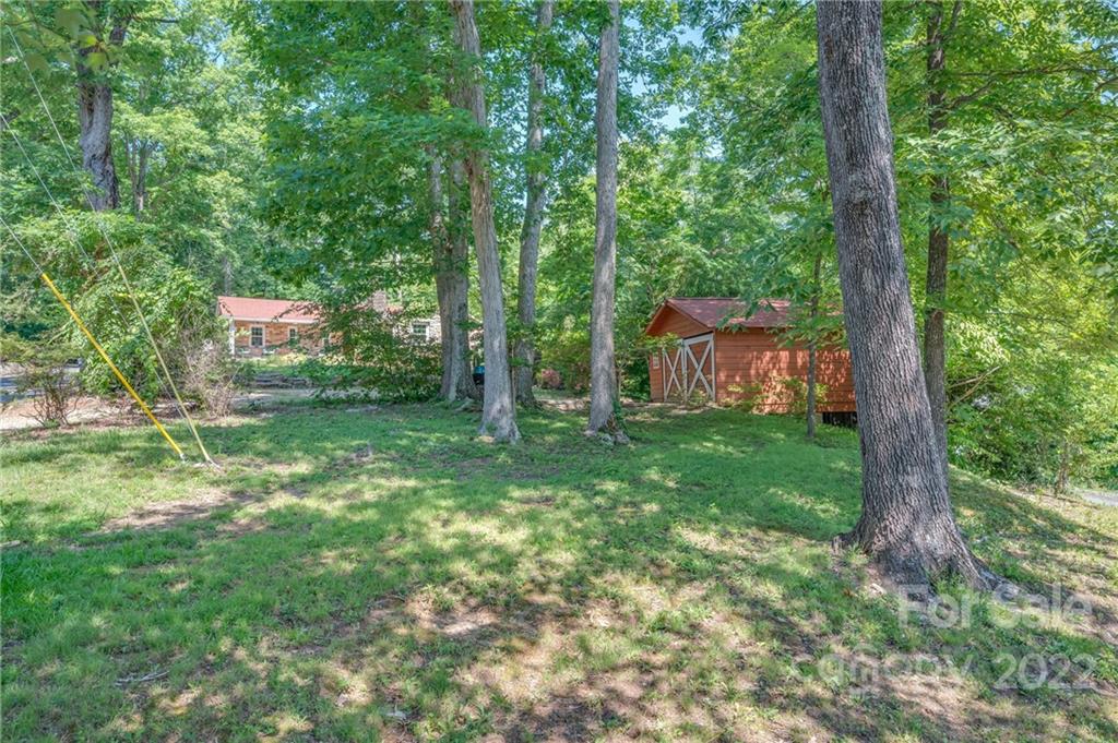 146 Hidden Hill Road Tryon, NC 28782 - Photo 38 of 43 a backyard of a house with lots of green space